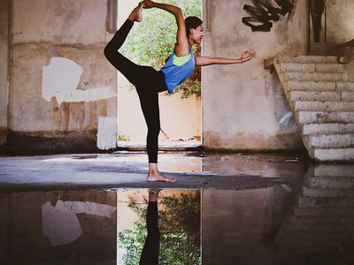 A calm, empty room with natural light and a yoga mat.